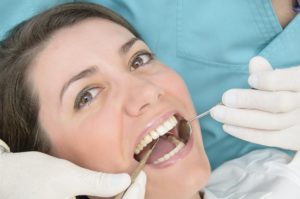 woman receiving oral cancer screening